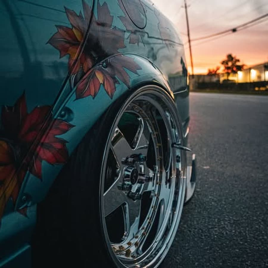 Custom wheel and suspension setup parked at the car meet on Bissonnet